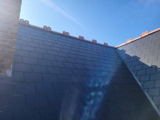 Slate roof with a clear blue sky in the background.